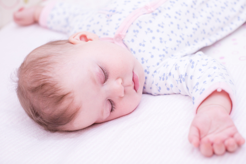 Baby Sleeping in Crib on Back 